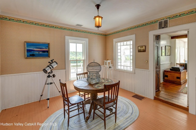 3721 Ridge Rd, Hamden, NY 13782 - dining room with a wainscoted wall, hardwood / wood-style floors, wallpapered walls, and plenty of natural light