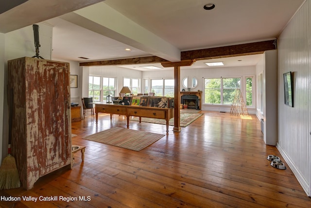 3721 Ridge Rd, Hamden, NY 13782 - living area with beam ceiling, wood-type flooring, healthy amount of natural light, a fireplace, and a desk