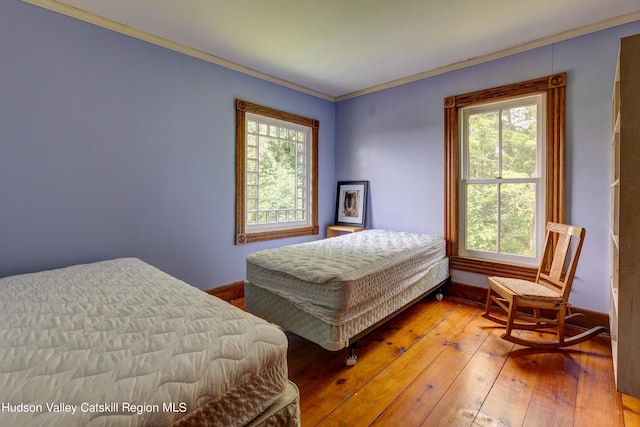 3721 Ridge Rd, Hamden, NY 13782 - bedroom with multiple windows, ornamental molding, baseboards, and hardwood / wood-style floors