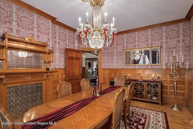 1 Waddell Ave, Fort Plain, NY 13339 - dining space with ornamental molding, wood finished floors, wainscoting, a chandelier, and wallpapered walls
