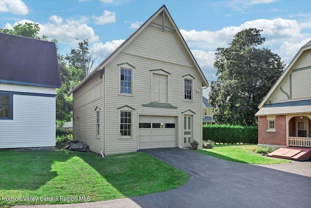 1 Waddell Ave, Fort Plain, NY 13339 - view of side of home featuring asphalt driveway, a lawn, and a garage