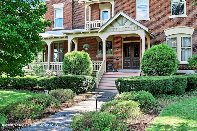 1 Waddell Ave, Fort Plain, NY 13339 - view of exterior entry featuring brick siding and a porch