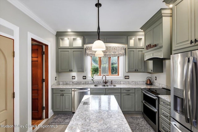 1 Waddell Ave, Fort Plain, NY 13339 - kitchen featuring stainless steel appliances, a sink, wood finished floors, crown molding, and hanging light fixtures