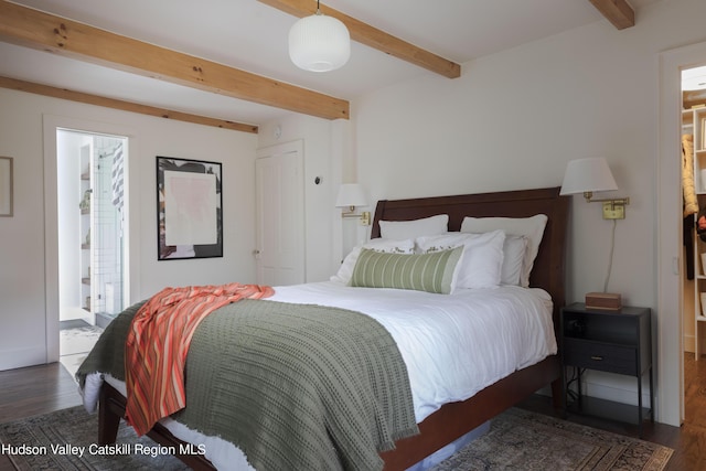 bedroom with beam ceiling, dark hardwood / wood-style floors, and ensuite bathroom