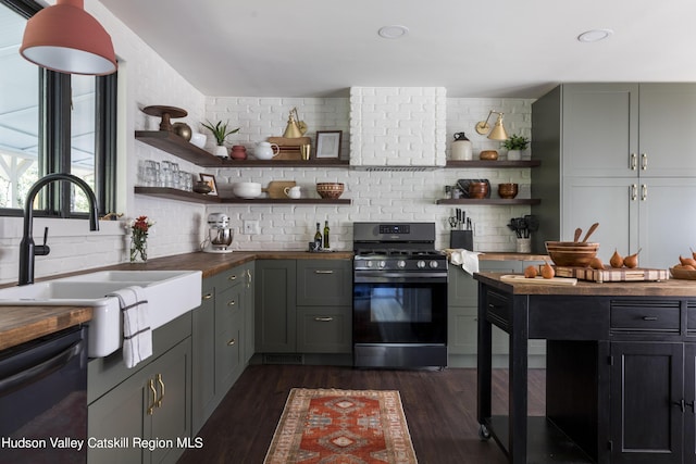 kitchen featuring gas range, butcher block counters, sink, black dishwasher, and dark hardwood / wood-style flooring