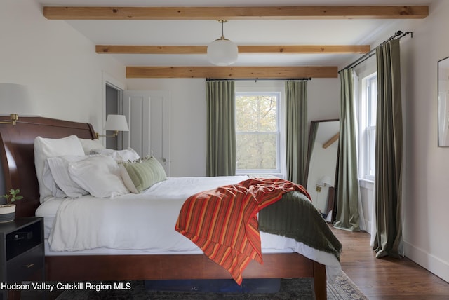 bedroom featuring beamed ceiling and hardwood / wood-style flooring