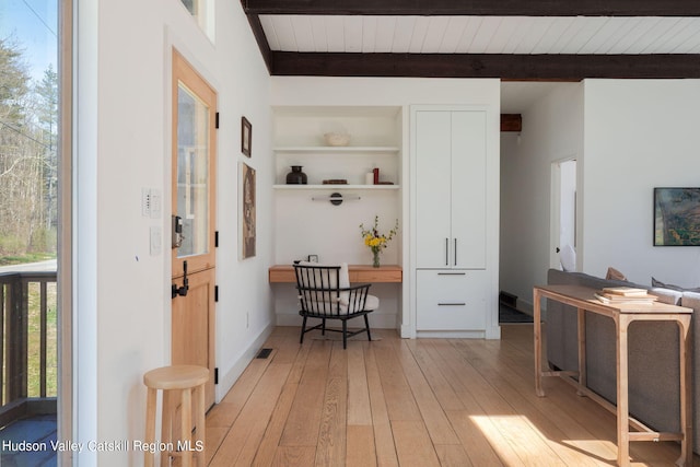 interior space with beam ceiling, light hardwood / wood-style flooring, and wooden ceiling