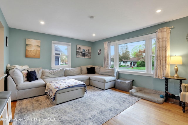 living room featuring recessed lighting, a wealth of natural light, and wood finished floors