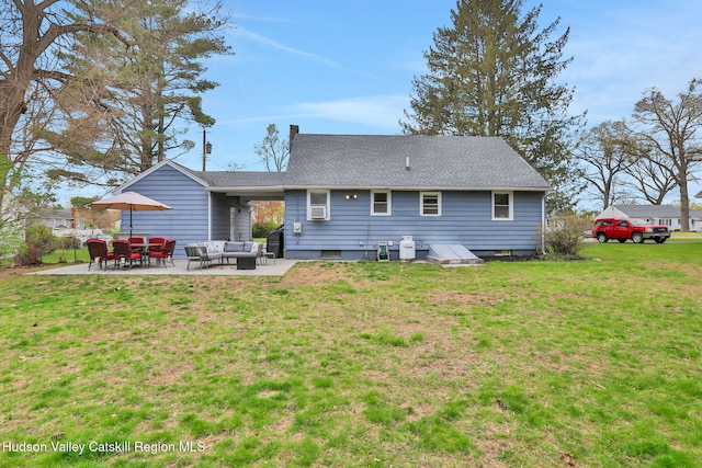 rear view of house with a patio, a yard, and an outdoor hangout area