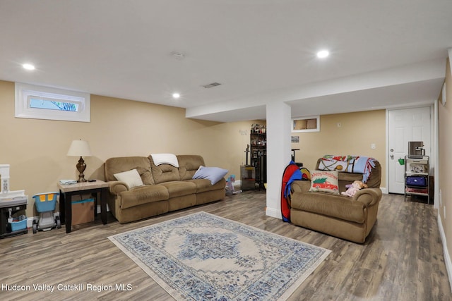 living room featuring wood finished floors, recessed lighting, visible vents, and baseboards