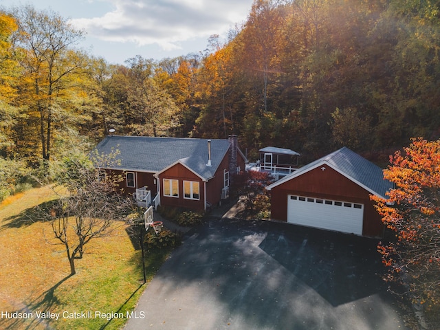 view of front of property with a garage, a front yard, and a carport