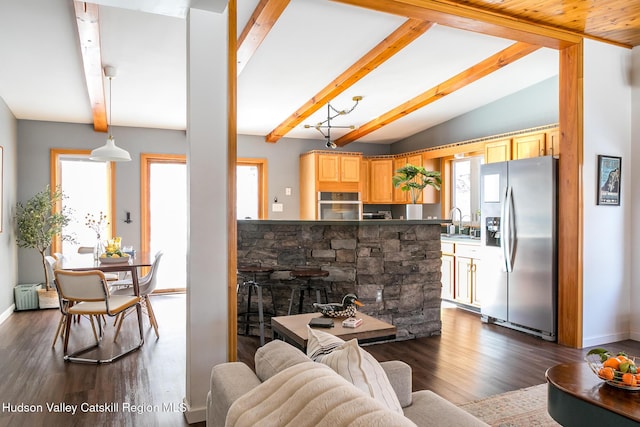 living room with sink, dark wood-type flooring, and vaulted ceiling with beams