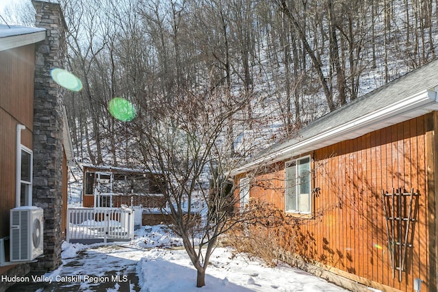 view of snow covered exterior with ac unit