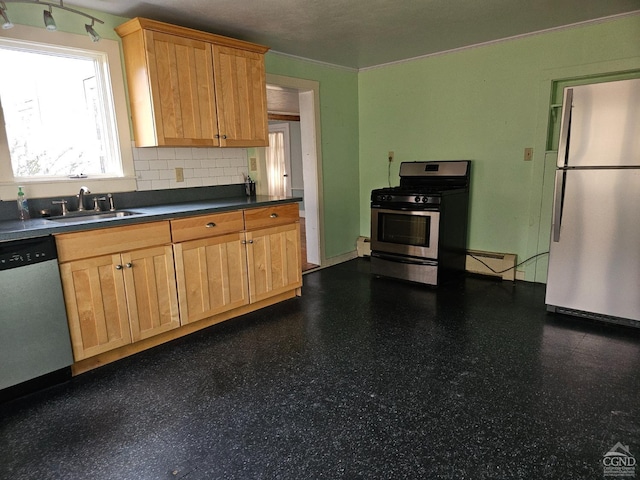 kitchen featuring stainless steel appliances, a sink, dark flooring, and dark countertops