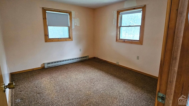 carpeted empty room with baseboard heating and baseboards