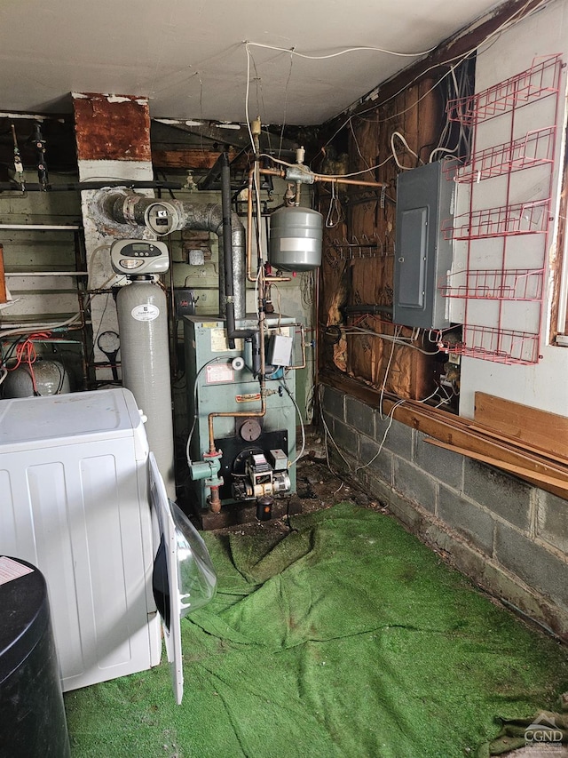 utility room featuring electric panel and a heating unit