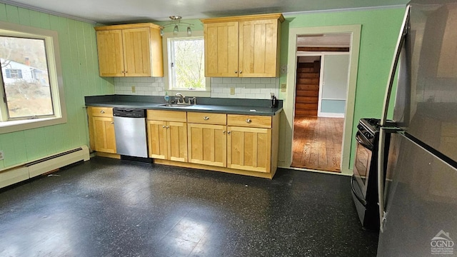 kitchen featuring appliances with stainless steel finishes, a sink, ornamental molding, dark countertops, and light brown cabinetry