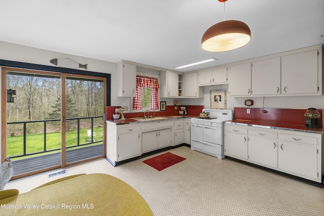 kitchen with white cabinets, a sink, pendant lighting, visible vents, and white range with gas cooktop