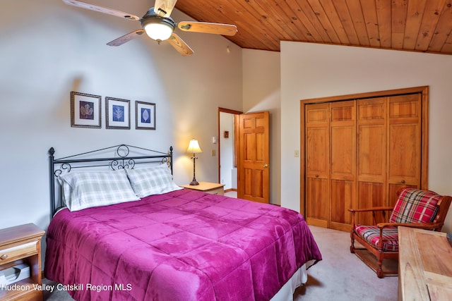 carpeted bedroom with ceiling fan, vaulted ceiling, wood ceiling, and a closet