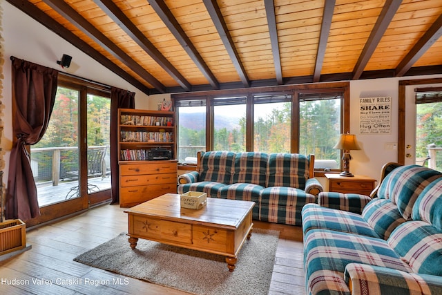 living room featuring vaulted ceiling with beams, light hardwood / wood-style floors, and wood ceiling