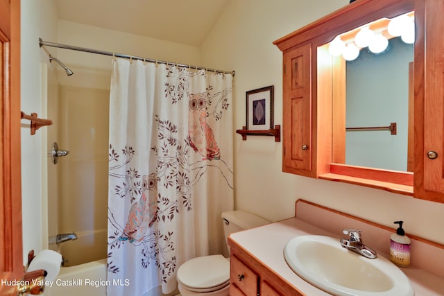 full bathroom with lofted ceiling, vanity, shower / bath combo, and toilet