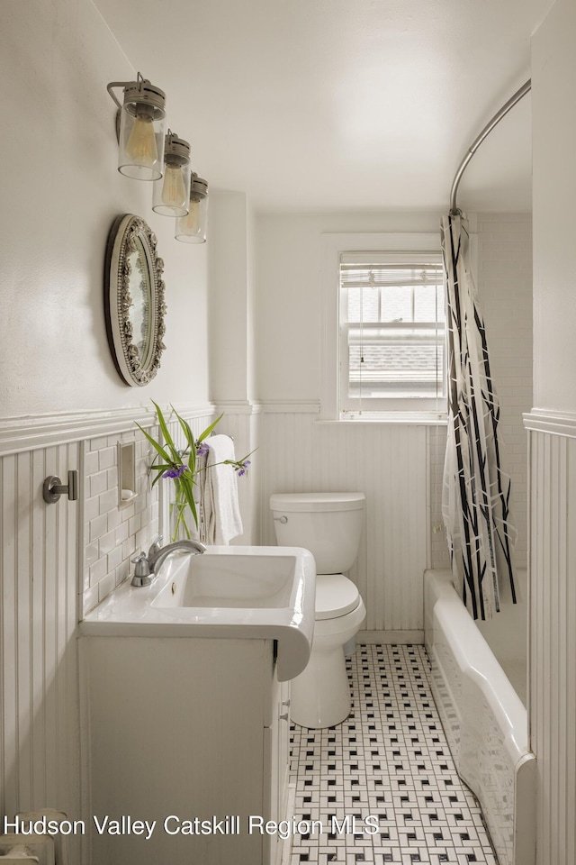 827 Union St, Hudson, NY 12534 - full bathroom with a wainscoted wall, vanity, shower / tub combo, and tile patterned flooring