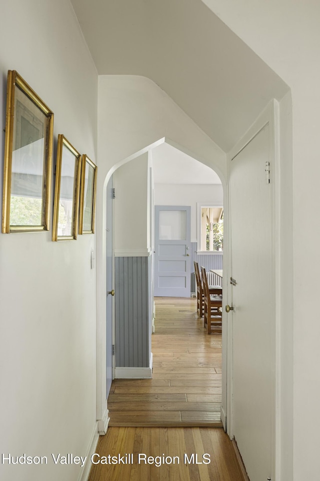 827 Union St, Hudson, NY 12534 - hall featuring arched walkways, hardwood / wood-style floors, and lofted ceiling