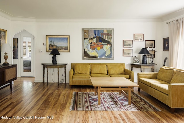 827 Union St, Hudson, NY 12534 - living area with wood finished floors, arched walkways, and ornamental molding