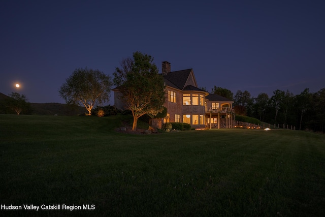 315 Weed Mine Rd, Copake, NY 12521 - back of house at twilight featuring a lawn and a chimney