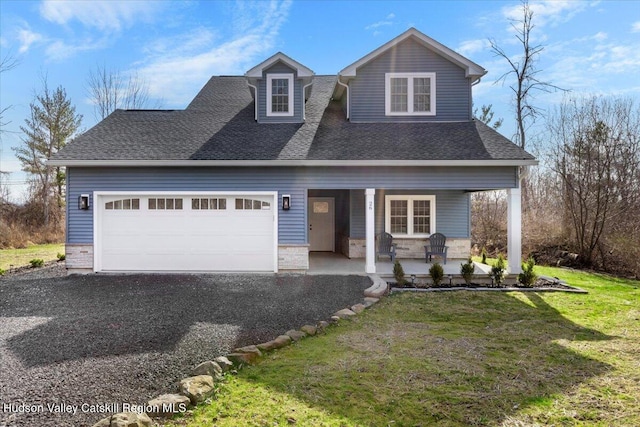 26 Debbie Dr, Athens, NY 12015 - view of front of house featuring a front yard, stone siding, covered porch, a garage, and gravel driveway