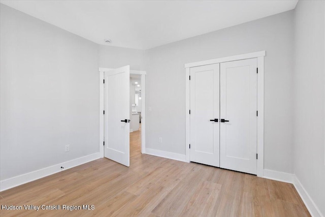 26 Debbie Dr, Athens, NY 12015 - unfurnished bedroom featuring a closet, light wood-style flooring, and baseboards