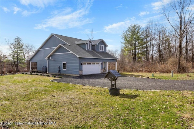 26 Debbie Dr, Athens, NY 12015 - view of side of home featuring an attached garage, a lawn, and aphalt driveway