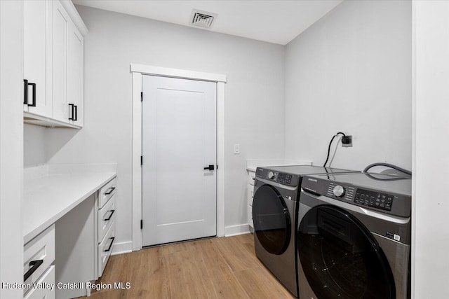 26 Debbie Dr, Athens, NY 12015 - clothes washing area with visible vents, baseboards, light wood-style floors, cabinet space, and washing machine and clothes dryer