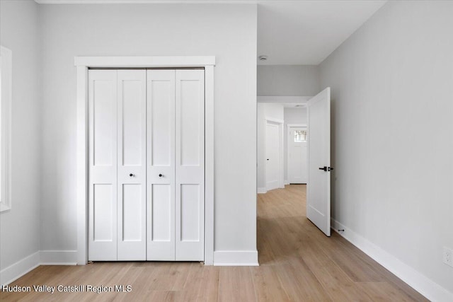 26 Debbie Dr, Athens, NY 12015 - unfurnished bedroom with light wood-style floors, a closet, and baseboards