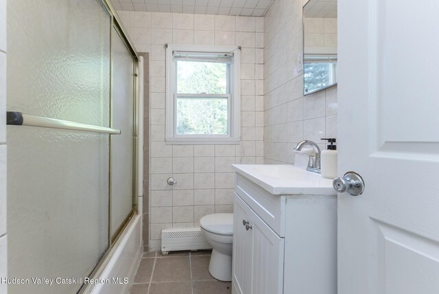 94 Tammany St, Kingston, NY 12401 - full bath featuring tile walls, tile patterned floors, toilet, vanity, and a baseboard radiator