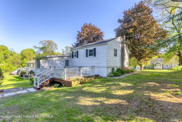 94 Tammany St, Kingston, NY 12401 - back of house featuring a wooden deck, an attached garage, a yard, and stairs