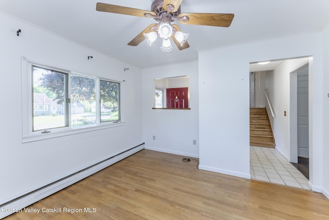 94 Tammany St, Kingston, NY 12401 - spare room featuring a baseboard heating unit, stairs, a ceiling fan, light wood-style flooring, and baseboards