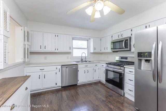94 Tammany St, Kingston, NY 12401 - kitchen with appliances with stainless steel finishes, a sink, dark wood finished floors, white cabinets, and light countertops