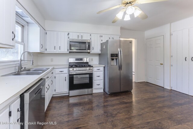 94 Tammany St, Kingston, NY 12401 - kitchen with appliances with stainless steel finishes, a sink, light countertops, dark wood-type flooring, and a ceiling fan