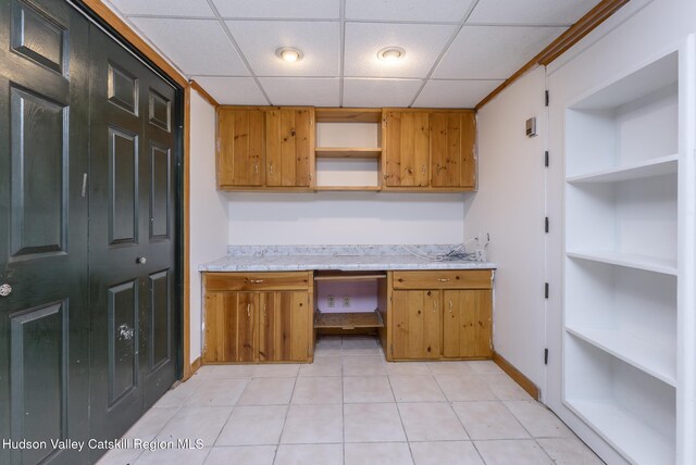 94 Tammany St, Kingston, NY 12401 - kitchen with open shelves, light countertops, a drop ceiling, brown cabinetry, and baseboards