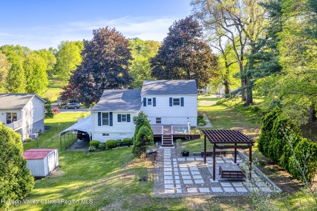 94 Tammany St, Kingston, NY 12401 - back of house featuring a lawn, stairway, a deck, an outdoor structure, and a storage unit