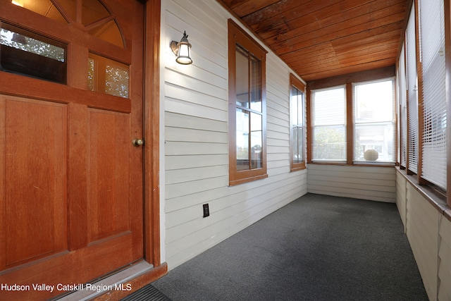 unfurnished sunroom featuring wooden ceiling