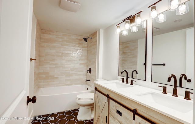 full bathroom with toilet, tiled shower / bath, tile patterned flooring, and vanity