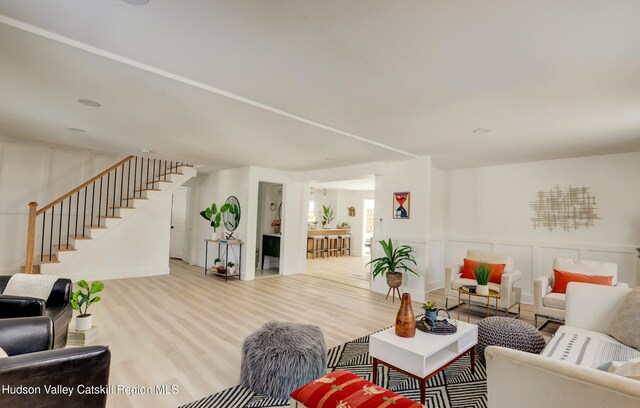 living room with a wealth of natural light and light hardwood / wood-style floors