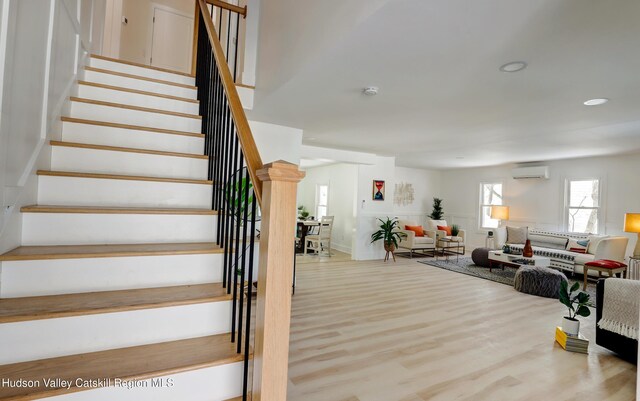 kitchen with decorative light fixtures, sink, light wood-type flooring, appliances with stainless steel finishes, and white cabinets