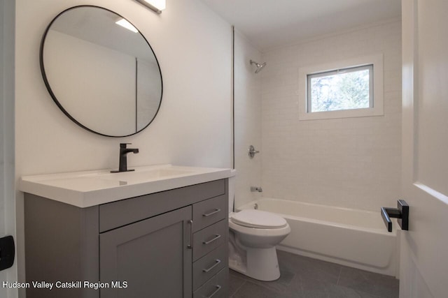 full bathroom featuring tile patterned flooring, bathing tub / shower combination, toilet, and vanity