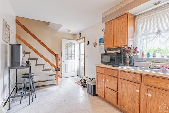 14 Montross St, Saugerties, NY 12477 - kitchen with a sink, black microwave, healthy amount of natural light, and light countertops