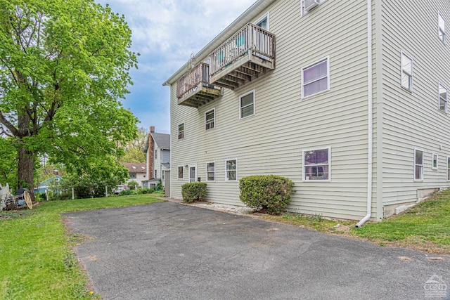 14 Montross St, Saugerties, NY 12477 - view of home's exterior featuring a balcony and asphalt driveway