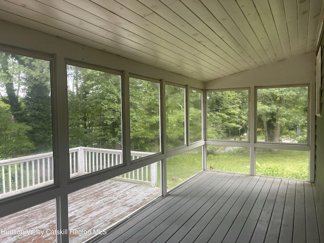 18 Marys Ave, Saugerties, NY 12477 - unfurnished sunroom with plenty of natural light, lofted ceiling, and view of wooded area