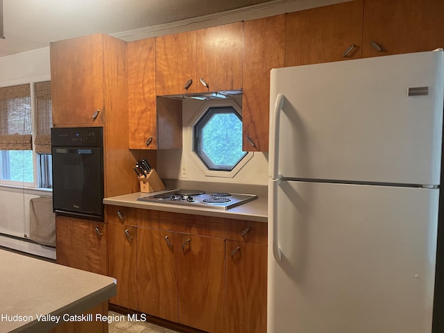 18 Marys Ave, Saugerties, NY 12477 - kitchen with freestanding refrigerator, oven, stainless steel electric cooktop, a baseboard heating unit, and brown cabinetry